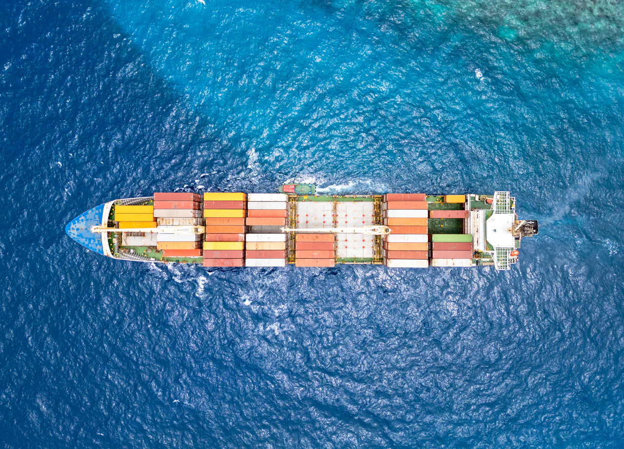 Aerial view of a container ship travelling across the sea